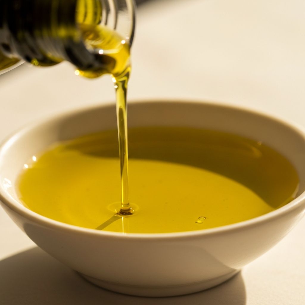 Close-up of extra-virgin olive oil in ceramic dish